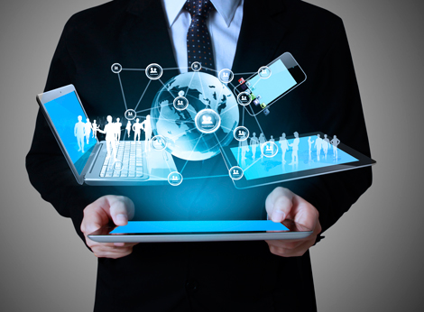 Business professional holding a tablet with connected devices and global network graphics