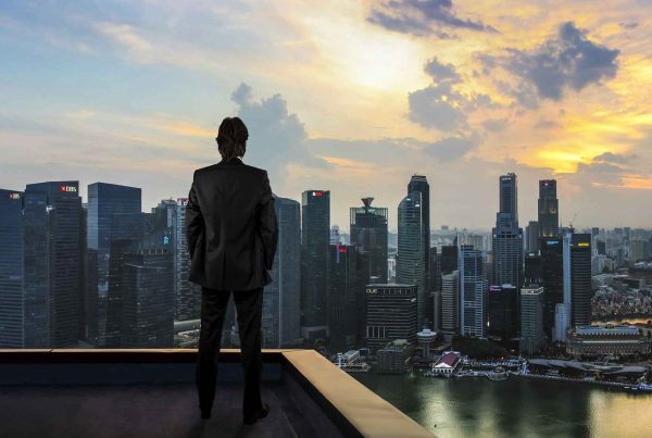 Businessman watching the city on the rooftop of skyscraper